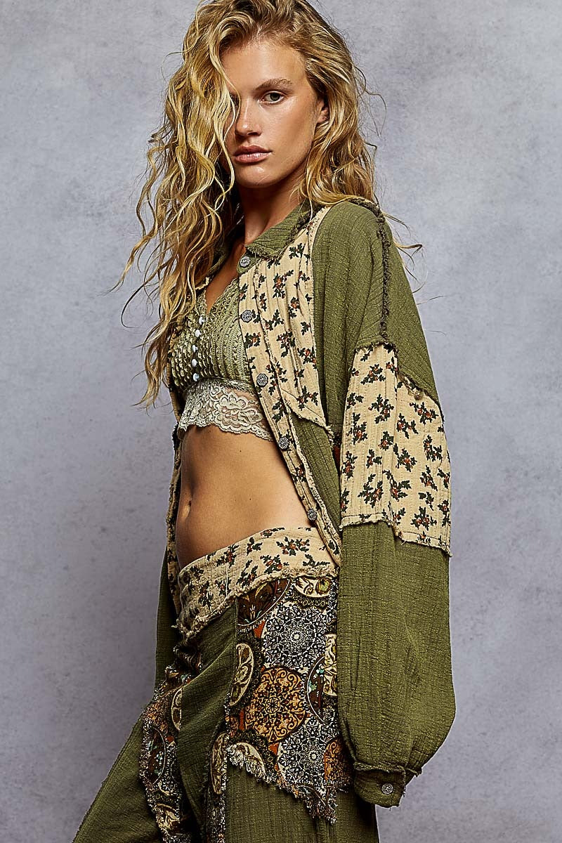 Woman wearing a green and patterned outfit against a gray background