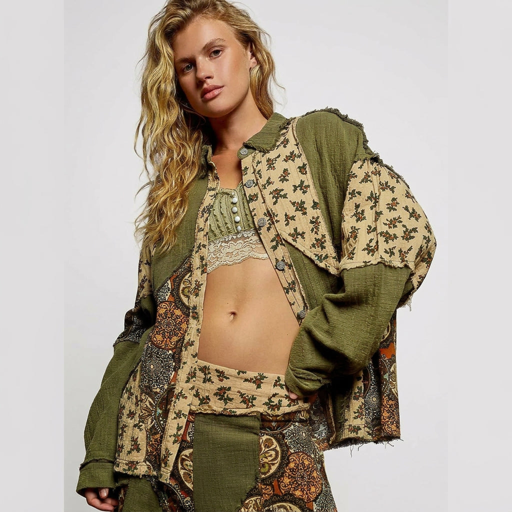 Woman wearing a patterned outfit with a green jacket against a gray background
