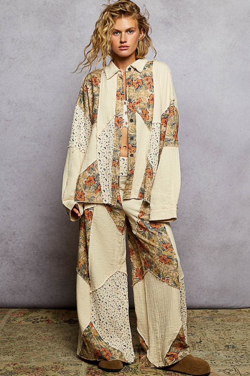 Woman wearing a patchwork outfit with floral and abstract patterns against a gray background