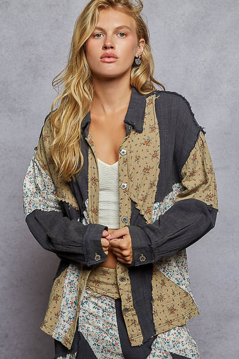 Woman wearing a patchwork jacket with floral patterns on a gray background
