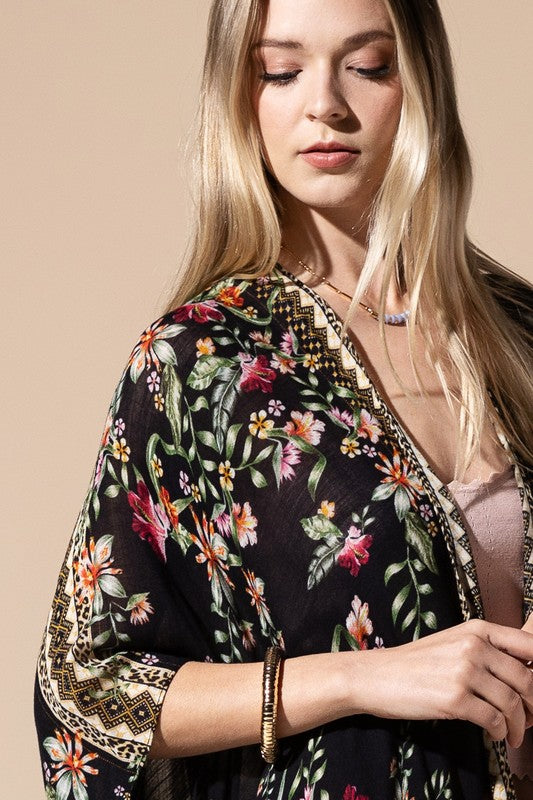 a woman wearing a black floral kimono