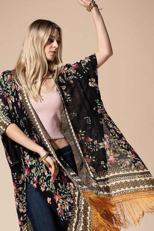 a woman wearing a black floral kimono