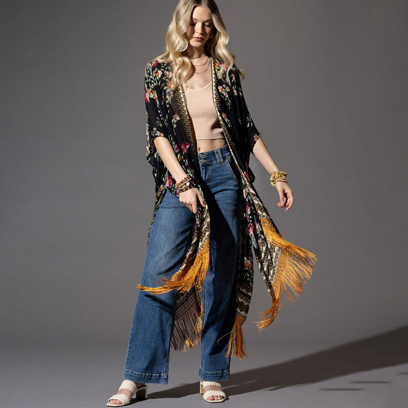 a woman in jeans and a jacket posing for a picture