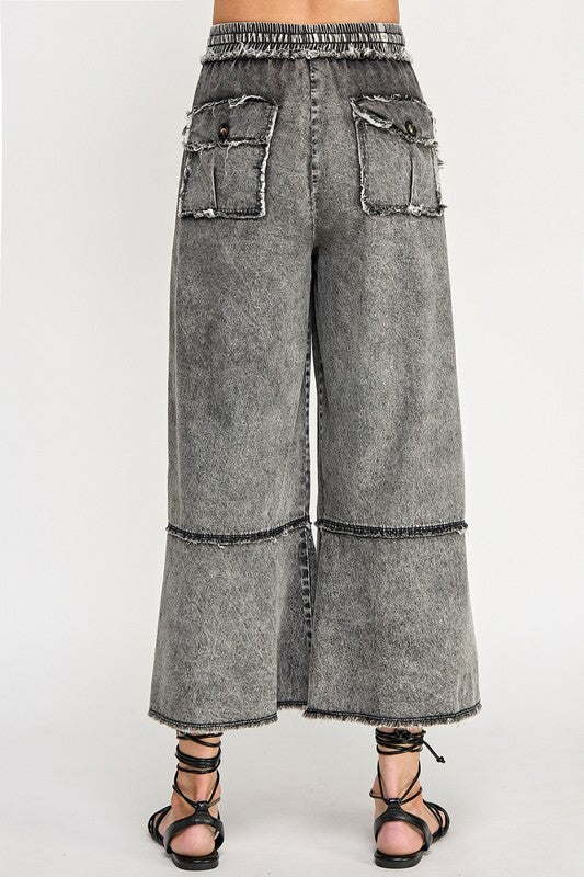 Wide-leg gray jeans on a white background