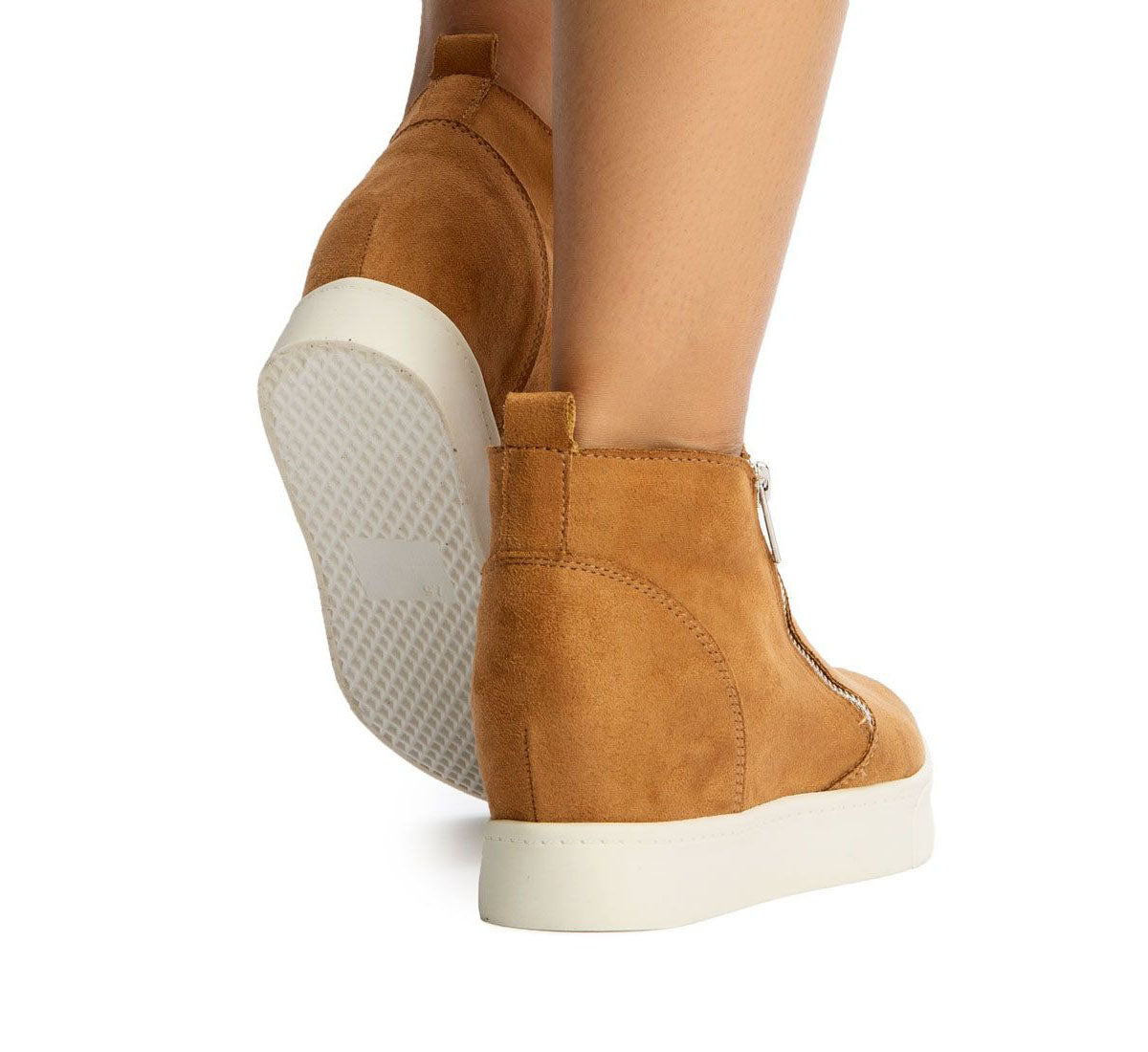 Tan wedge sneakers with white soles on a white background