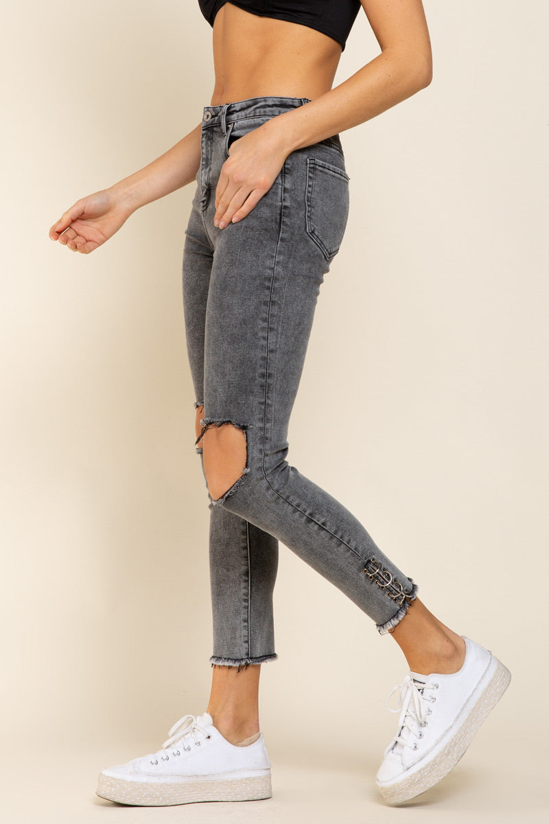 a woman in a black crop top and ripped jeans