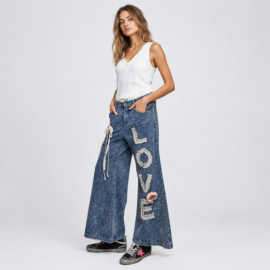 POL Clothing indigo LOVE appliqué wide-leg pants, angled front view with lace letters