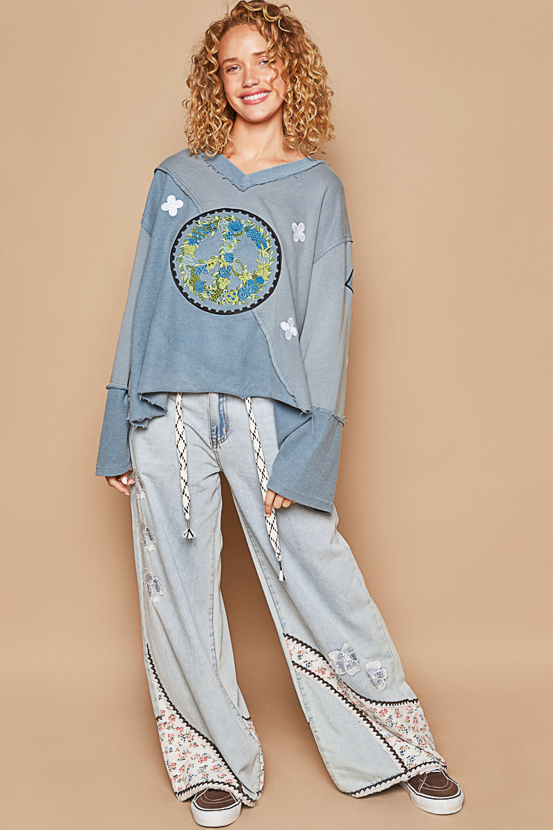 a woman wearing a blue sweatshirt and pants