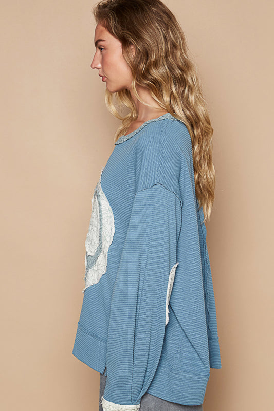 a woman standing in front of a beige wall