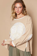 a woman wearing a sweater with a heart on it