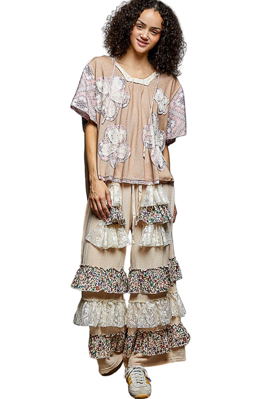 Woman wearing a floral dress with ruffled layers on a white background