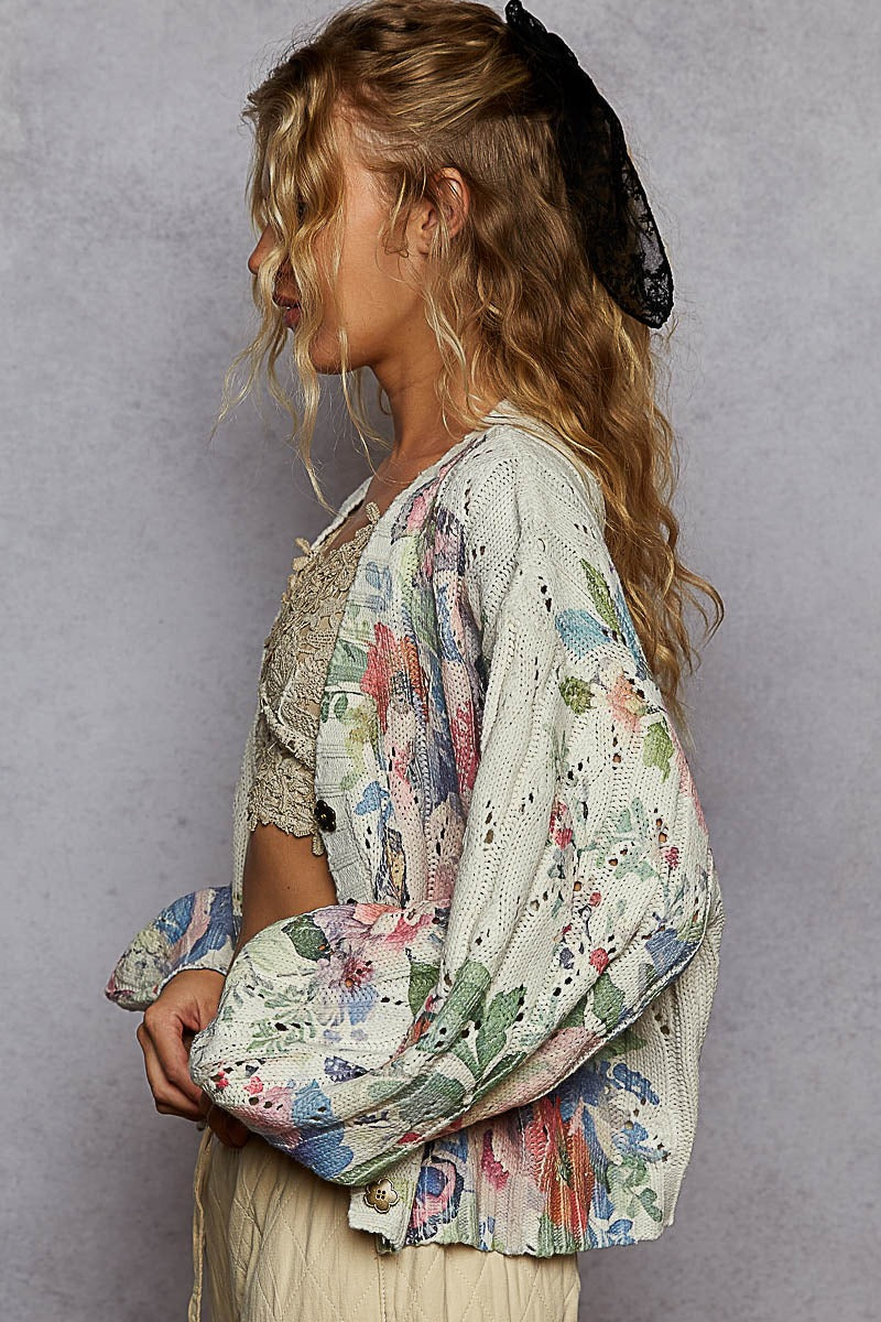 Woman wearing a floral kimono against a gray background