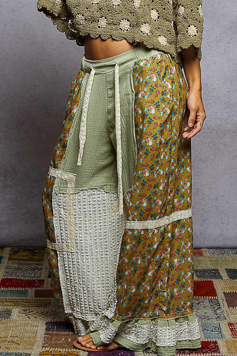 Person wearing a floral dress with a textured top on a patterned rug.