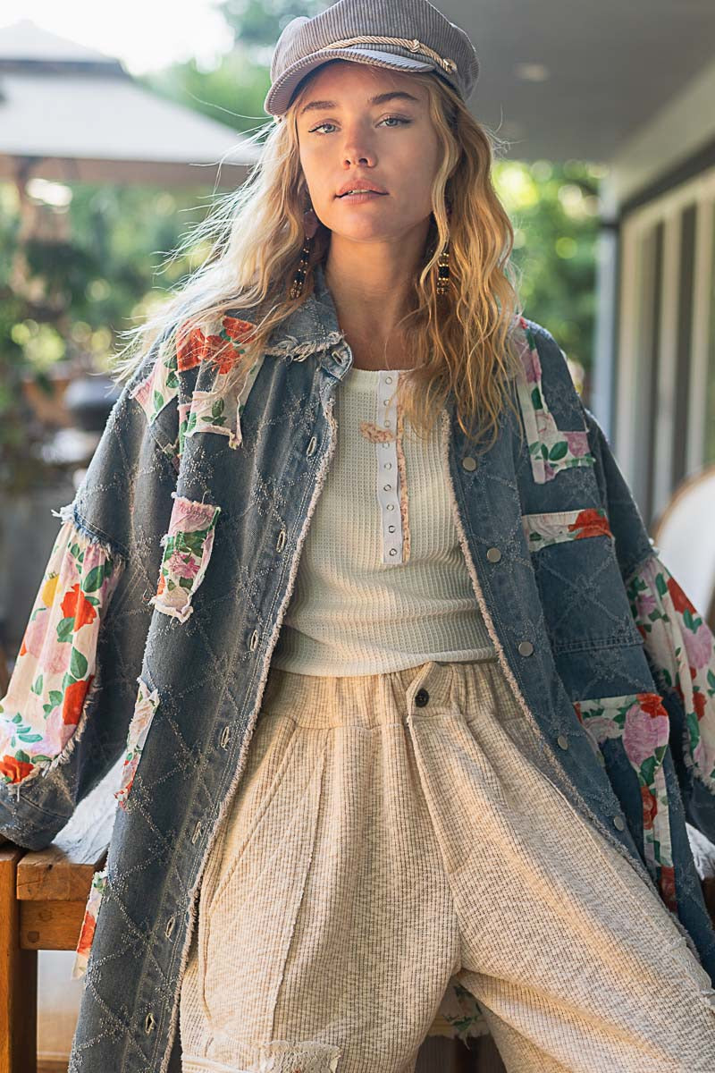 Woman wearing a floral jacket and cap outdoors