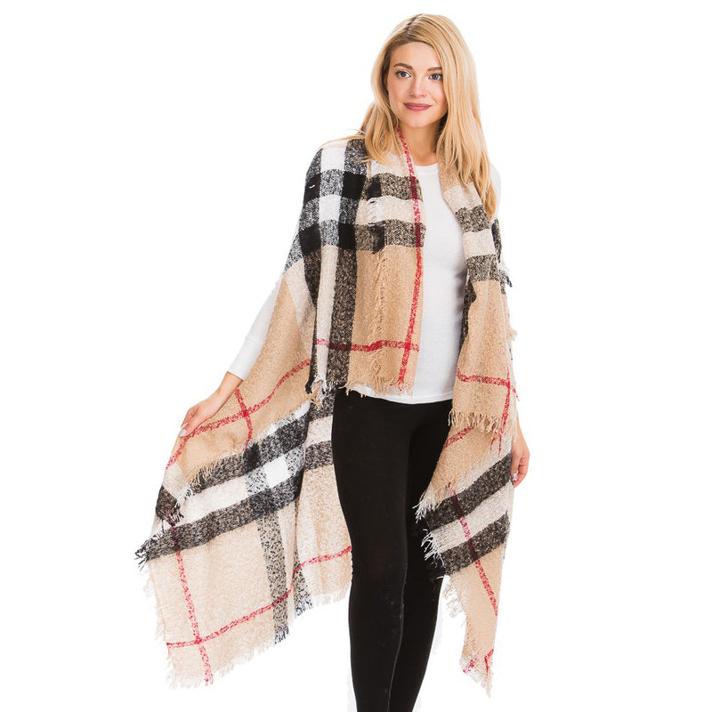 Women's camel plaid fringe shawl wrap draped over white sweater and black leggings, relaxed boho layer
