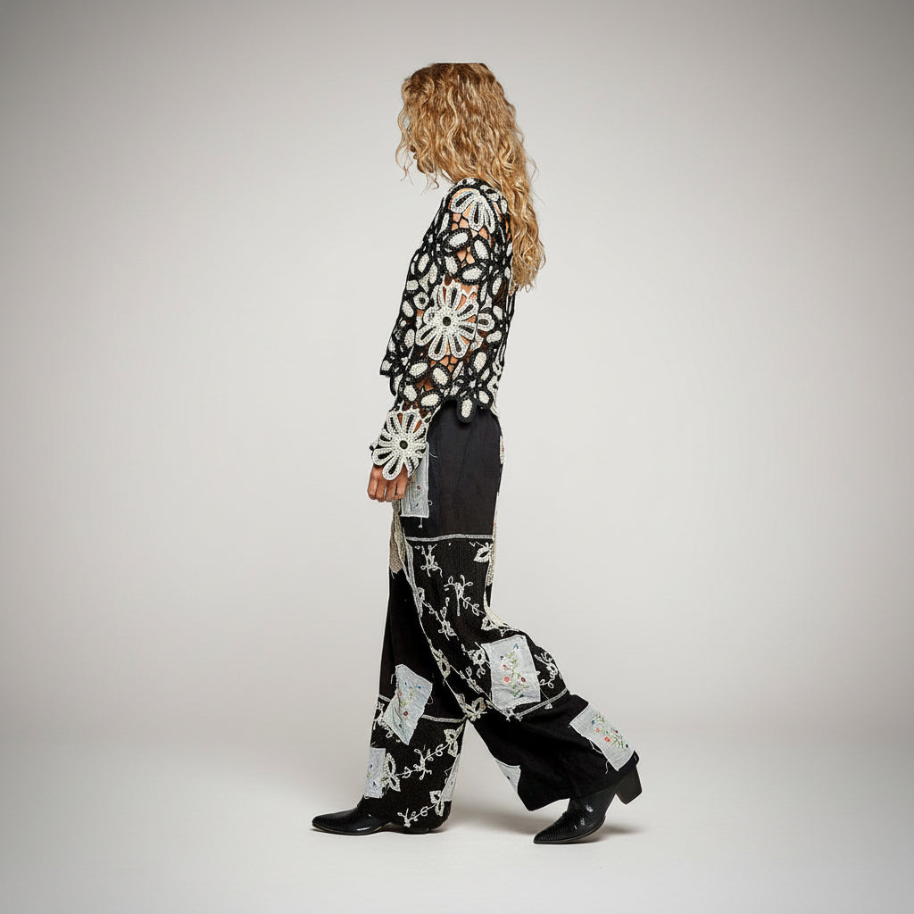 Women's black wide-leg lace patchwork pants side view walking silhouette relaxed woven fit