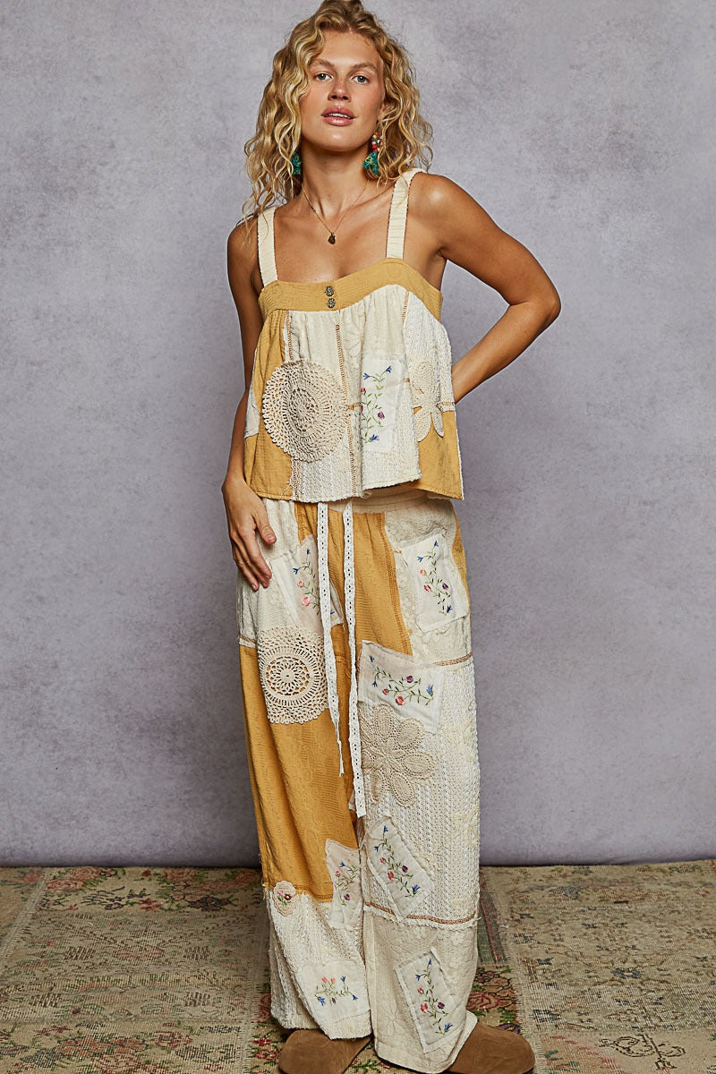 Woman wearing a patchwork dress with a neutral background