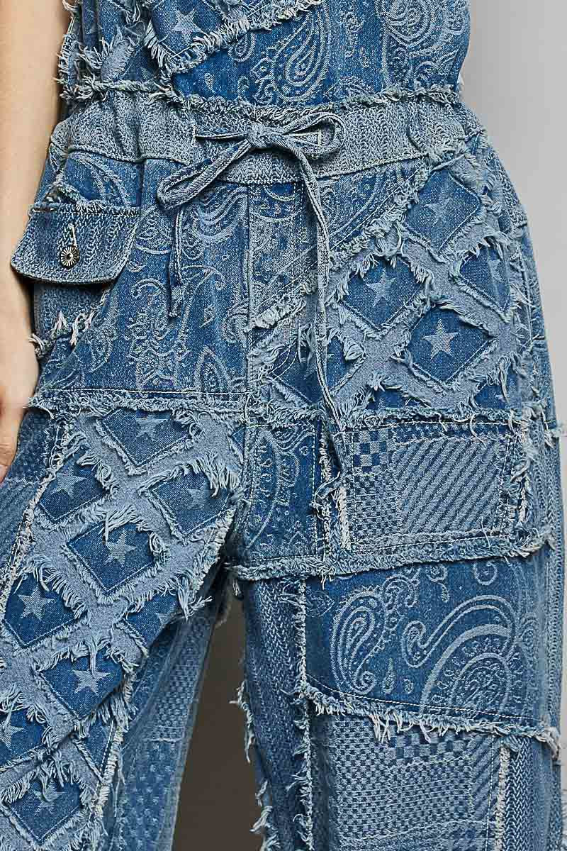 Blue denim patchwork outfit with a patterned design on a plain background