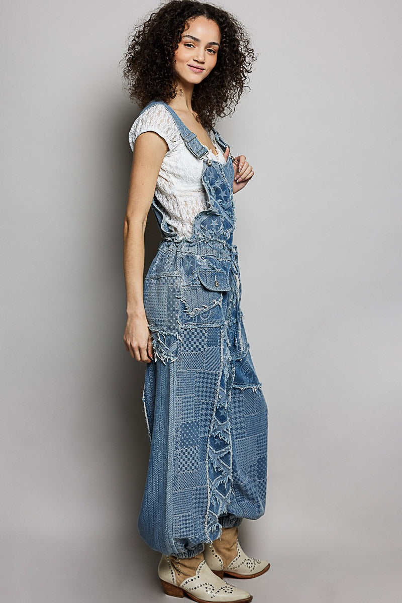 Woman wearing a long, patterned denim dress against a plain background