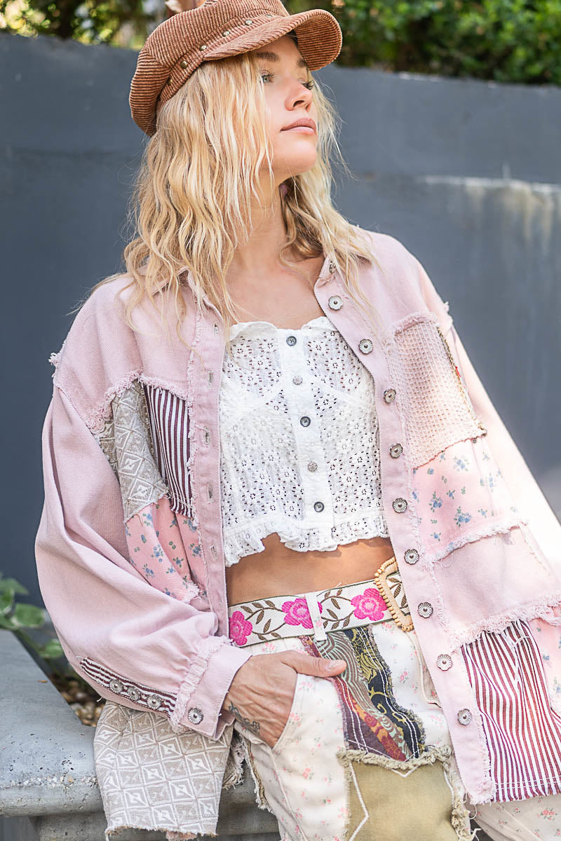 a woman wearing a hat and a pink jacket
