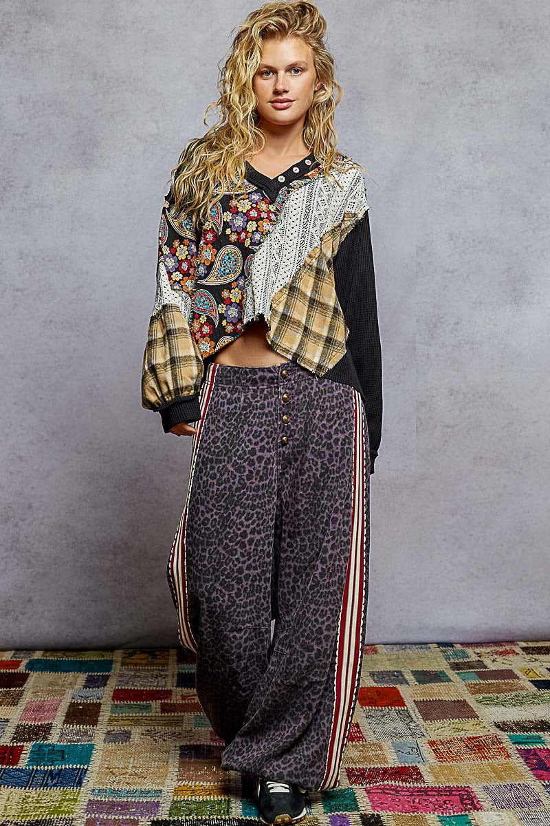 Woman wearing a patterned outfit with a colorful background