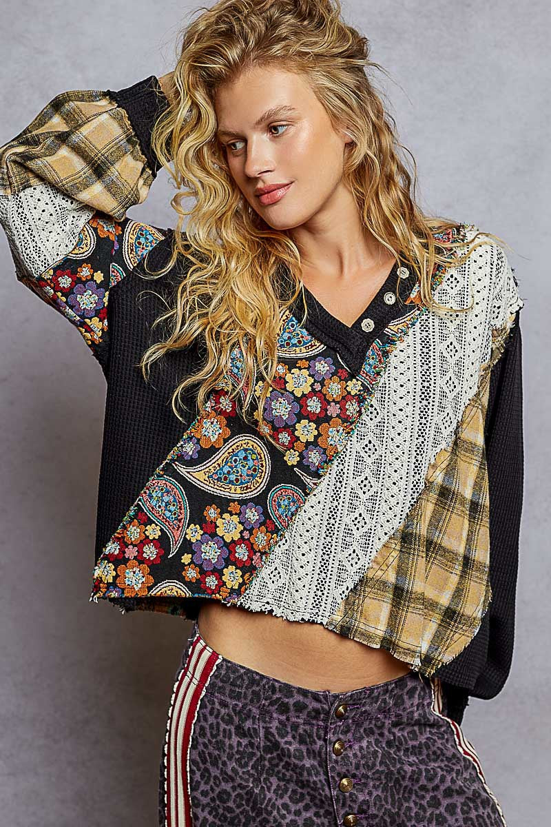 Woman wearing a colorful, patterned jacket with a gray background