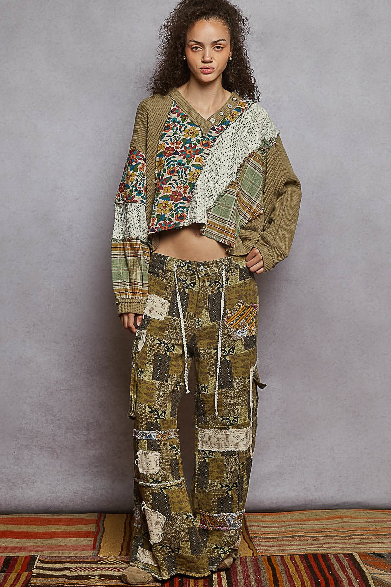 Woman wearing a patchwork outfit against a gray background