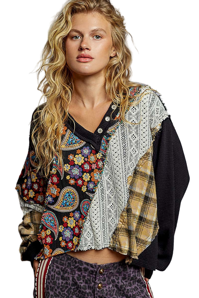 Woman wearing a colorful, patterned jacket with a white background