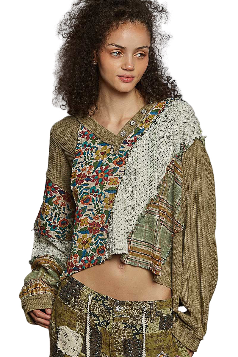 Woman wearing a patchwork outfit with floral and plaid patterns on a white background