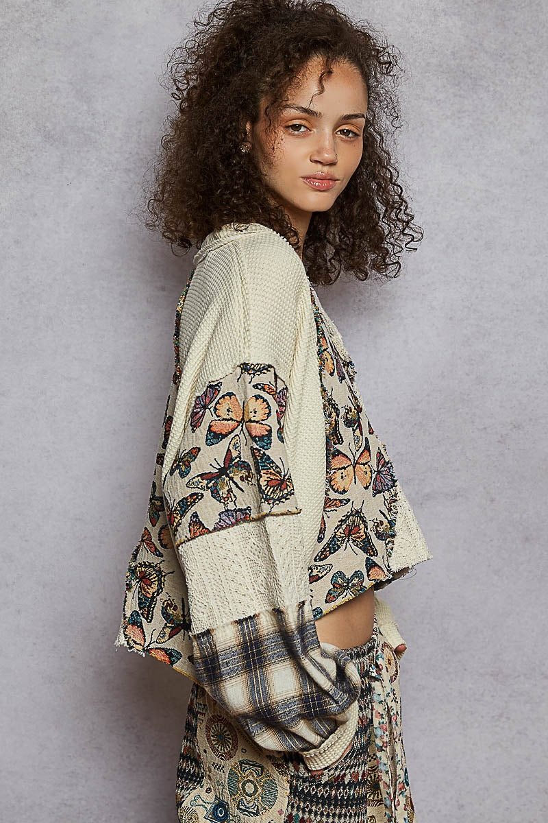 Woman wearing a patterned outfit with a neutral background