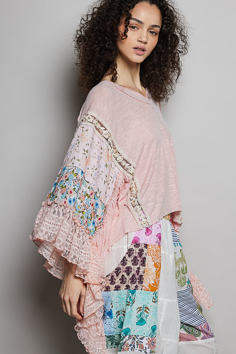 Woman wearing a pink and patterned outfit against a plain background