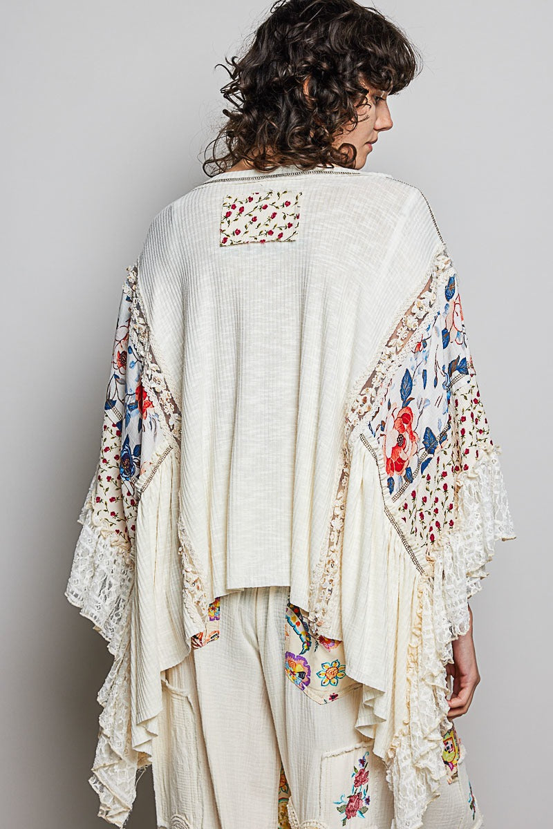 Woman wearing a floral kimono-style garment with a plain background