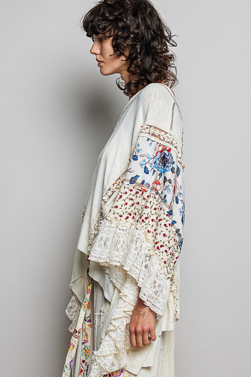 Woman wearing a floral embroidered dress against a gray background