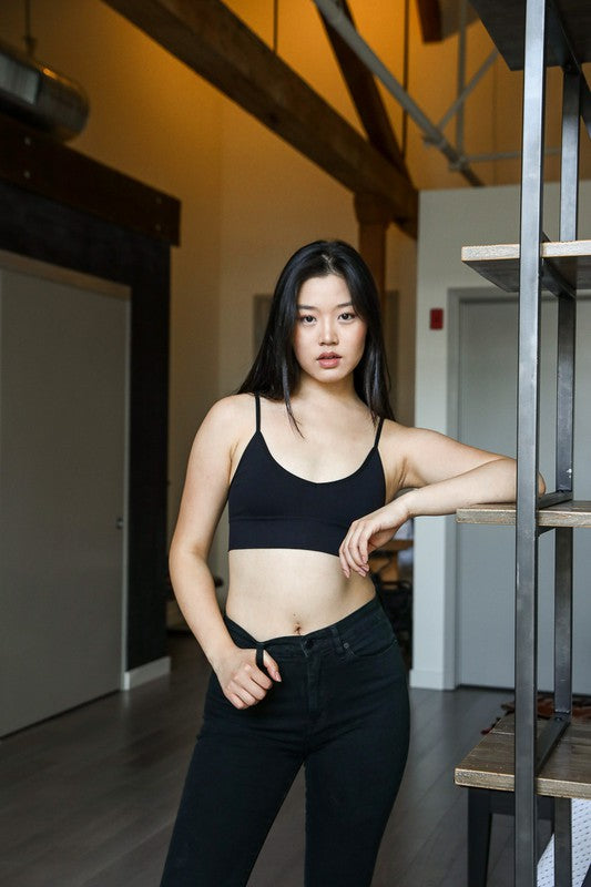 a woman standing next to a metal shelf