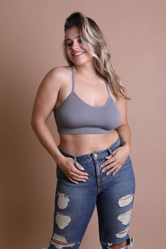 a woman posing for a picture in ripped jeans