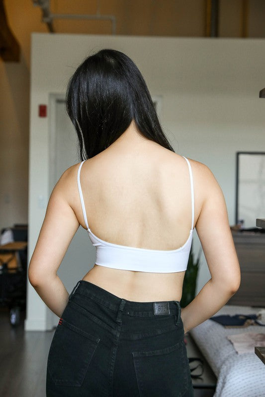 a woman standing in a room with her back to the camera
