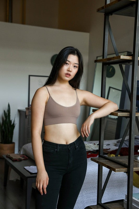 a woman standing in front of a book shelf