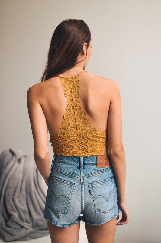 a woman in high waisted shorts and a yellow top