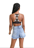 a woman in a black top and denim shorts