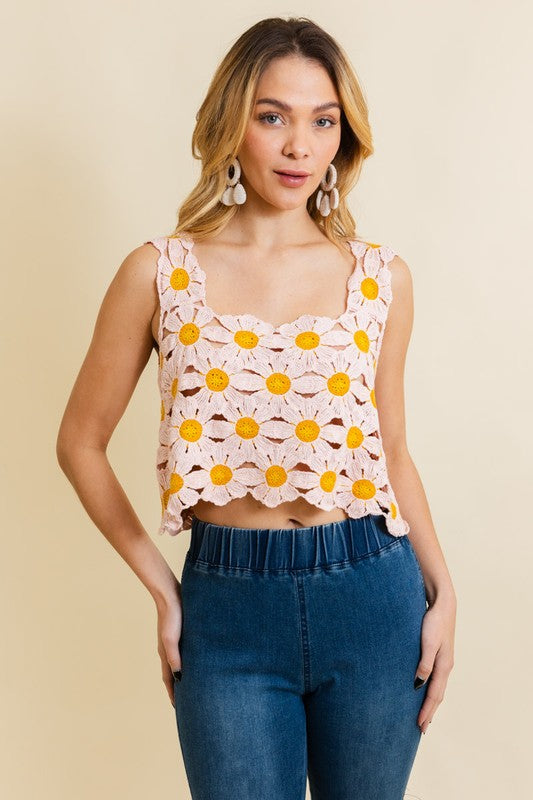 a woman wearing a crop top with flowers on it