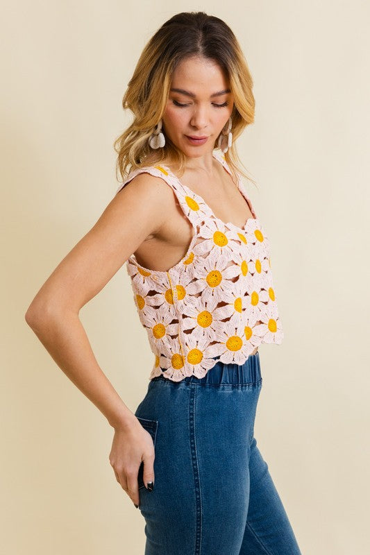 a woman wearing a pink top with yellow flowers on it