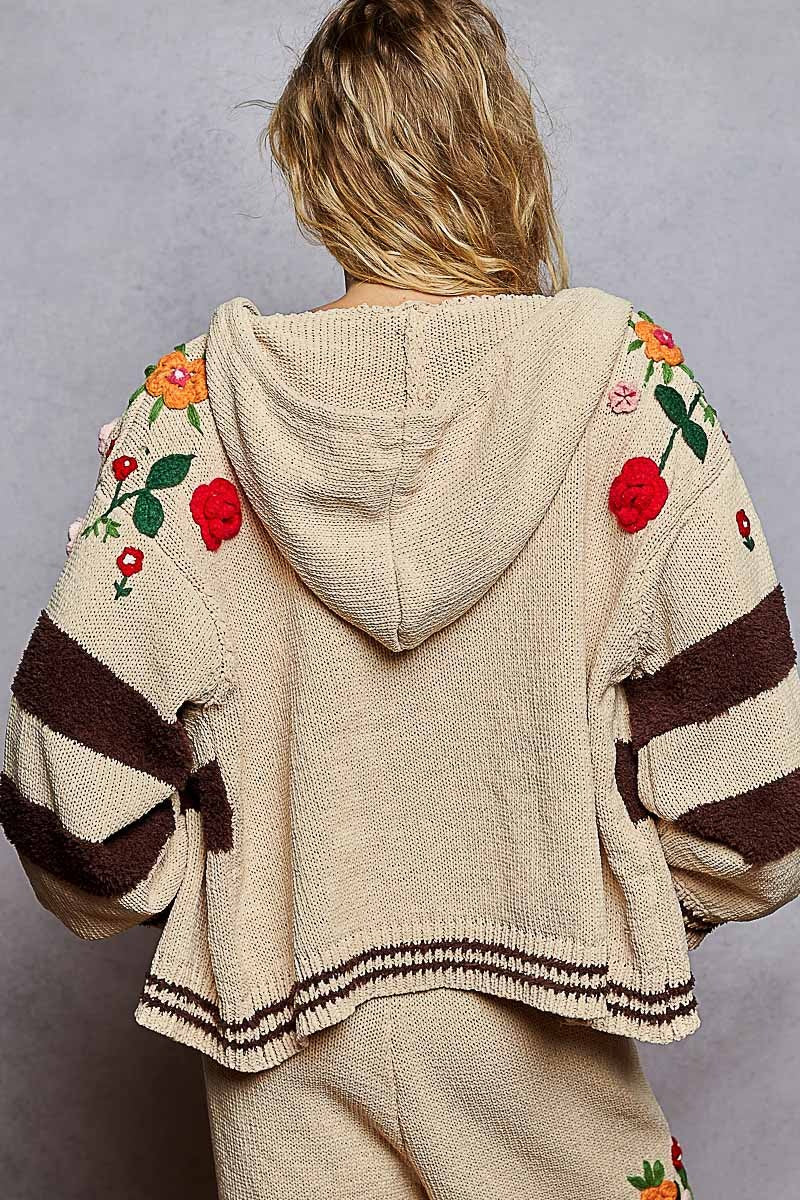 Beige hoodie with floral embroidery on a plain background