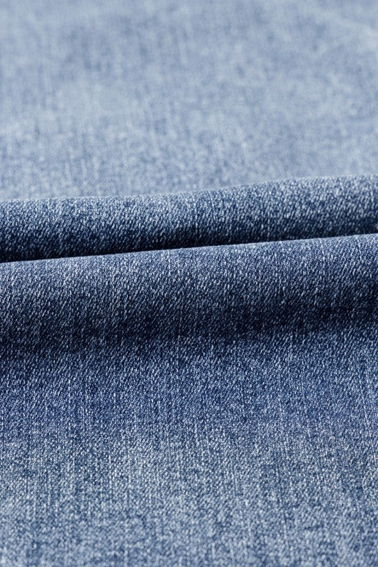 Close-up of blue denim fabric with a subtle pattern