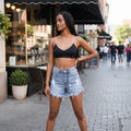 Model wearing Leto Collection black padded crop bralette top in front of shop storefront