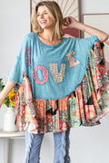 Woman wearing a colorful, patchwork-style top with 'LOVE' letters in various colors.