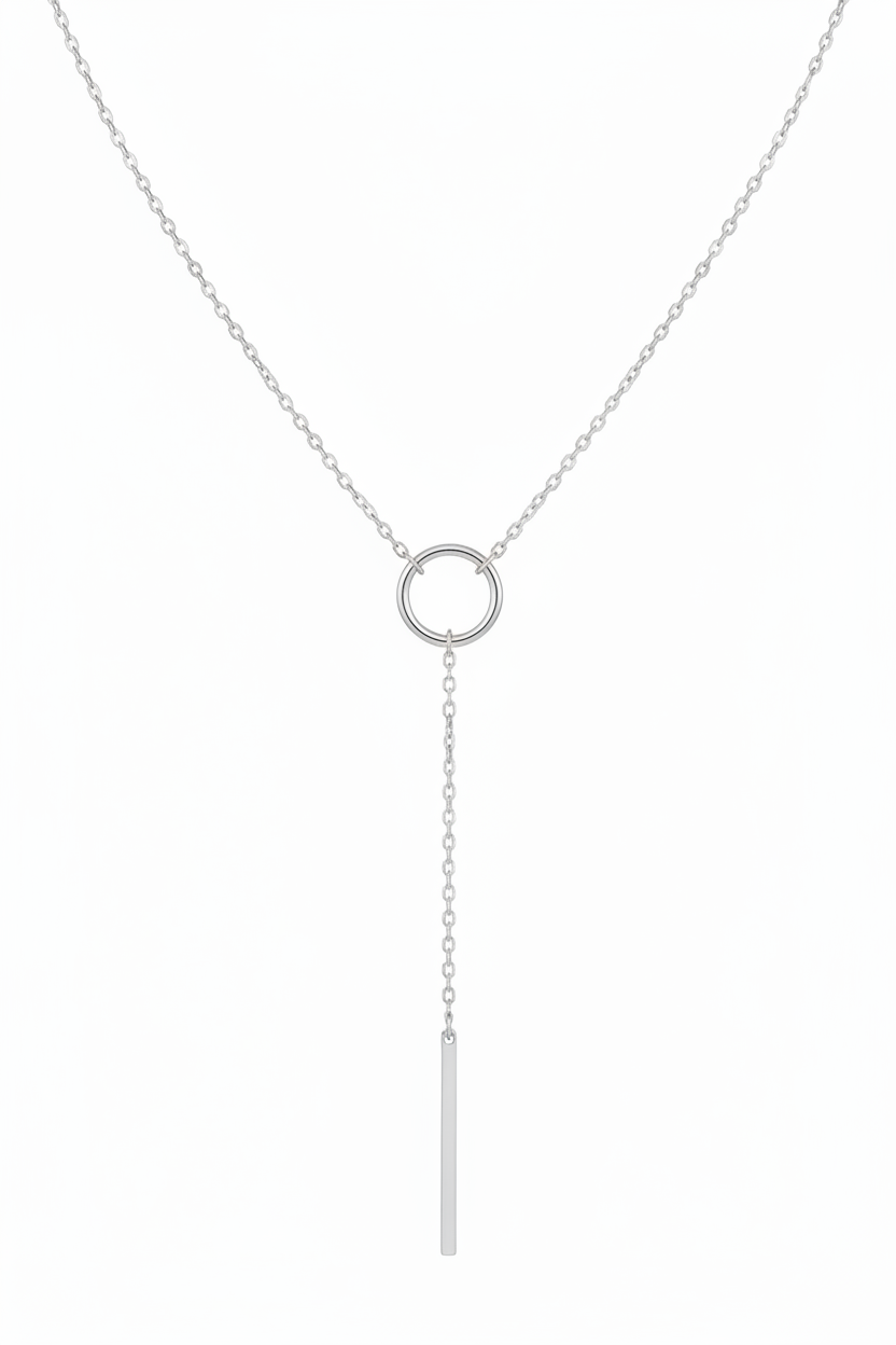 Silver necklace with a circular pendant and a long hanging bar on a white background