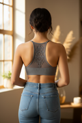 Leto grey racerback bralette on model, back view showing tattoo mesh mandala panel with jeans, natural light
