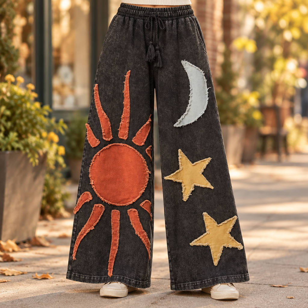 Mello women's black washed wide-leg hem with raw-edge sun, moon and star appliqués, close-up