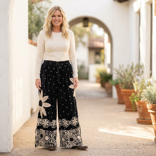Woman wearing A Rare Bird Shop black velvet polka dot pantaloons with crochet daisy appliqué and lace hems - BellanBlue