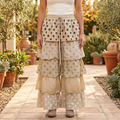 A Rare Bird Shop women's beige tiered polka dot pants, front view in a garden courtyard - BellanBlue